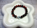 Red and Black Crackle Beaded Stretch Bracelet with Black and White Swirl Cross